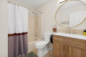 a bathroom with a toilet and a sink and a mirror at Earth Haus LITE in Fourth Crossing +23 photos