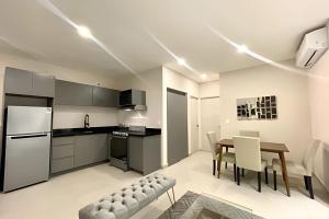 a kitchen and dining room with a table and chairs at Sophisticated APT Parking Work Gym BBQ WiFi MTY in Monterrey