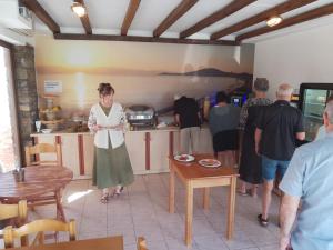 a group of people standing in a kitchen at Agios Prokopios Hotel in Agios Prokopios +64 photos