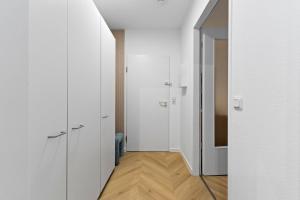a hallway with white walls and wooden floors at Cozy living in Gießen - free parking - balcony in Gießen