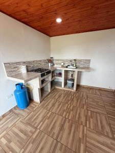 a kitchen with a counter top and a wooden ceiling at Casa campo Guatavita #02 in Montecillo