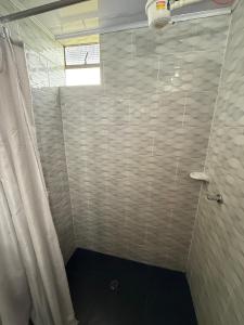 a bathroom with a shower with a shower curtain at Casa campo Guatavita #02 in Montecillo +1 photo