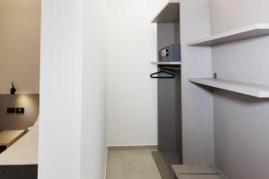 a room with white walls and white shelves at Harmonia B&B in Aversa