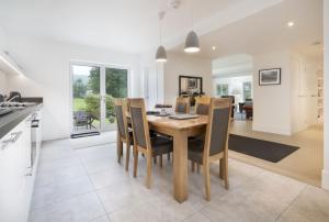 a kitchen and dining room with a table and chairs at Fellbeck Holiday Home - Cartmel in the Lake District in Cartmel