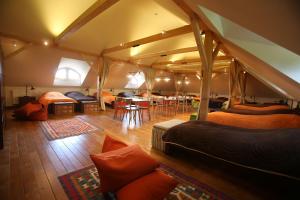 a room with beds and tables in a tent at Csodarabbik Útja Fogadó in Mád