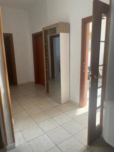 a hallway with two doors and a tile floor at Casa paradiso in Vasto