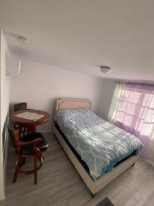 a small bedroom with a bed and a table at Cozy Studio in Quiet Neighborhood in Bradenton