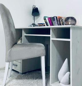 a desk with a chair and a book shelf at Mostar Luxury Apartment in Mostar