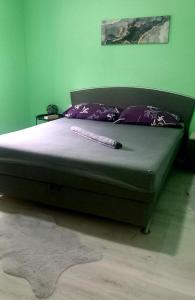 a large bed in a bedroom with purple pillows at Mostar Luxury Apartment in Mostar +5 photos