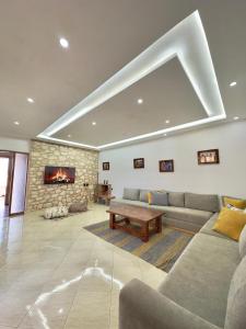 a living room with a couch and a fireplace at Chambre Agadir in Essaouira