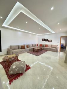 a living room with a couch and a table at Chambre Agadir in Essaouira +13 photos