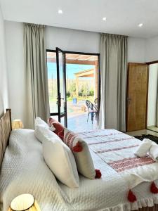 a bedroom with a large bed with pillows on it at Chambre Agadir in Essaouira