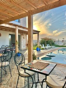 a patio with a table and chairs and a pool at Chambre Agadir in Essaouira