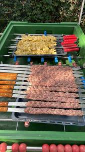 a grill with many different types of meat on it at Beheizter Wohnwagen mit Küche und Duschbad in Berlin