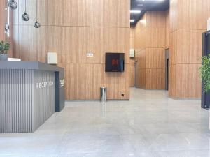 an empty lobby with wooden walls and a hallway with a door at La Vita Batumi in Batumi
