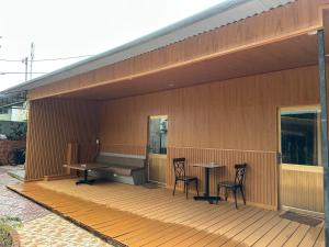 a wooden deck with two tables and chairs on a building at HOTEL Cù Lao 4 Tây Ninh in Tây Ninh