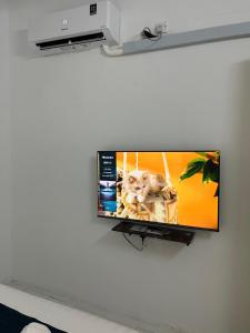 a flat screen tv hanging on a wall at Rest N Go CM in Ipoh