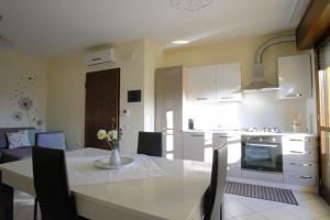 a kitchen and living room with a table and chairs at Casa di Stefy in Quartu SantʼElena +12 photos