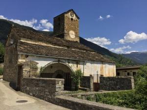 an old stone building with a clock tower at Casa Felipe Ordesa in Frajén