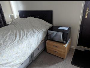 a small bedroom with a bed and a tv at The Gabriels in Shaw