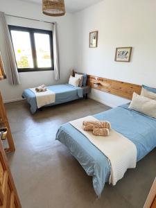 Postel nebo postele na pokoji v ubytování Villa Koa - Riders Surf n Bike + 62 fotografií