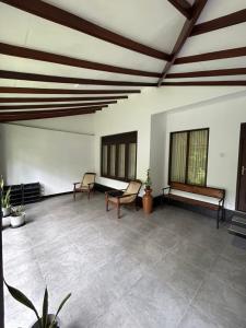 a large room with two chairs and a bench in it at Villa Petria in Galle