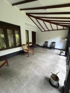 a large living room with chairs and a ceiling at Villa Petria in Galle
