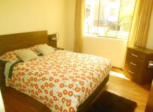 a bedroom with a bed and a window at casa alameda Miraflores in Miraflores