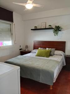 Un dormitorio con una cama grande con almohadas verdes. en Habitación 1 en piso compartido con acceso Zonas comunes, en Marbella