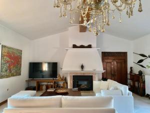 a living room with a white couch and a fireplace at Casa Bali Costa Brava in Llofríu