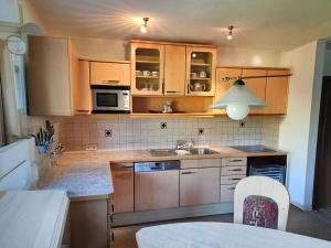 a kitchen with wooden cabinets and a sink at Haus Johanna in Wenns +2 photos