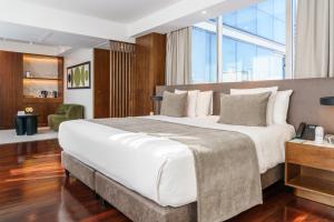 a bedroom with a large bed with a large window at Mio Buenos Aires in Buenos Aires +42 photos