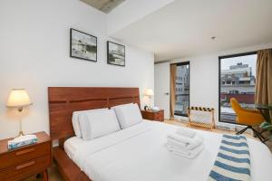 a bedroom with a bed and a desk and a chair at Chic Hideaway - Downtown Hotspot in Montréal