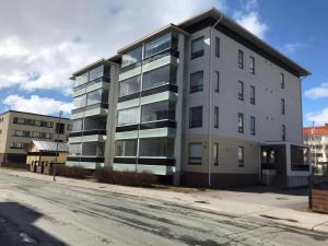 an apartment building on the corner of a street at Convenient Studio for 1 with Sauna in Kemi