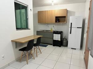 eine Küche mit einem Kühlschrank sowie einem Tisch und Stühlen in der Unterkunft Apartamento Flat 303 COP30 in Belém