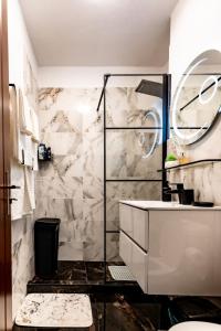 a white bathroom with a marble wall at Luxury Riverside Apartment Băile Herculane in Băile Herculane
