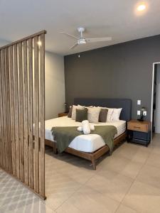a bedroom with a bed in a room with a fan at Morada Living in Guadalajara