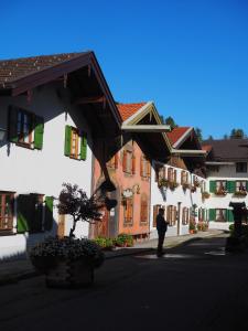 a man standing in front of a row of buildings at Karls Design Apartments Mittenwald in Mittenwald