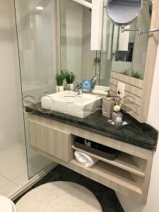a bathroom with a sink and a mirror at Oscar Freire Confort in Sao Paulo