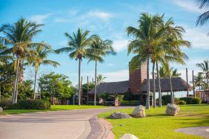 a road in front of a house with palm trees at Casa Oasis B-Nayar Gated, Beach Club, Free Shuttle in Cruz de Huanacaxtle