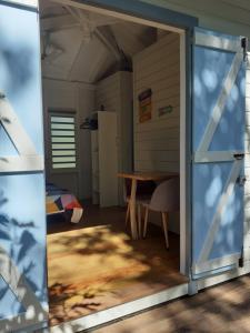 an open door to a room with a table at surf lodge in Deshaies