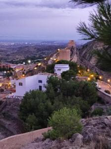 a view of a city from a hill at night at La Torre Blai in Jijona