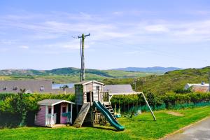 a playground with a slide next to a house at Under Gainne #2 in Downings