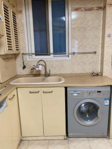 a kitchen with a sink and a washing machine at Shanghai single room in Shanghai