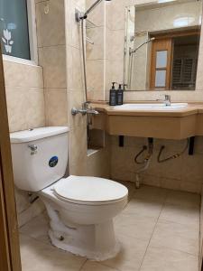 a bathroom with a toilet and a sink at Shanghai single room in Shanghai