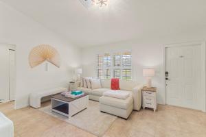 a living room with a couch and a table at Life is Good! in Port Saint Lucie