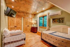 a bedroom with two beds and a flat screen tv at The Guf in Sugar Grove +42 photos