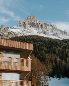 a person standing on a balcony of a mountain at Hotel Cristal in Obereggen