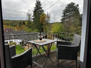 a table with a bottle of wine on a balcony at Hof Quartier 6 in Neunkirchen