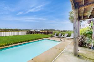 a swimming pool in the backyard of a house at Intracoastal Indulgence in Holden Beach